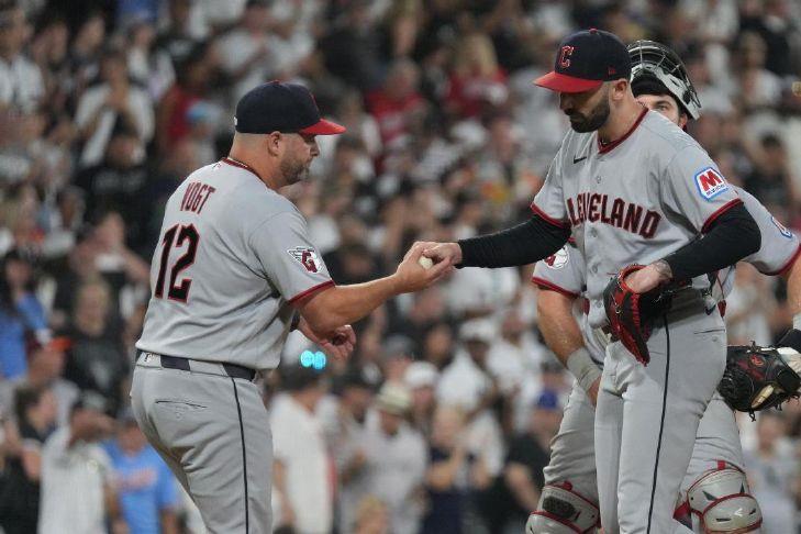 Cleveland Guardians manager Stephen Vogt, left, takes pitcher Colin Holderman, right, out of the game against the Chicago White Sox during the sixth inning of Saturday\'s game in Chicago.