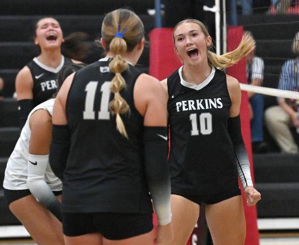 Perkins\' Reese Schaefer (10) gets fired up with teammate Braelyn Davie (11) after a kill during a match against Bellevue at Perkins High School on Monday, Aug. 31, 2026.
