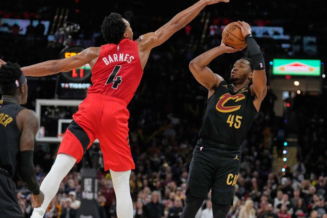Cleveland Cavaliers guard Donovan Mitchell (45) shoots as Toronto Raptors forward Scottie Barnes (4) defends in the second half in Game 7 of Sunday's playoff game in Cleveland.